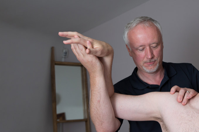 Michael helping a client with Shoulder treatment
