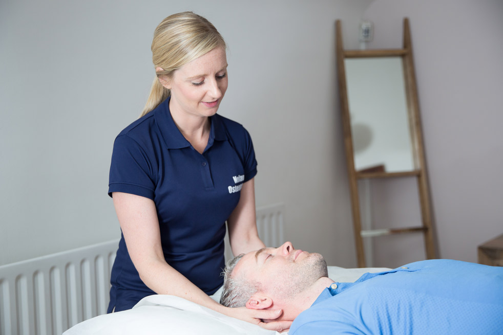 Maria with a patient with neck pain